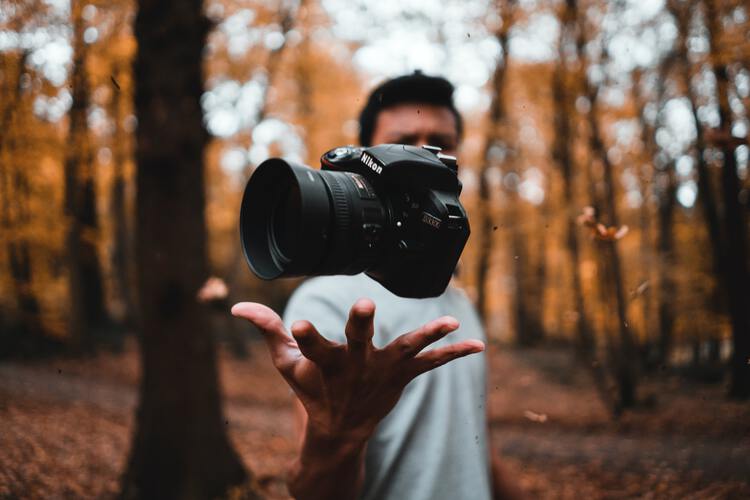 man throwing camera - free stock photos